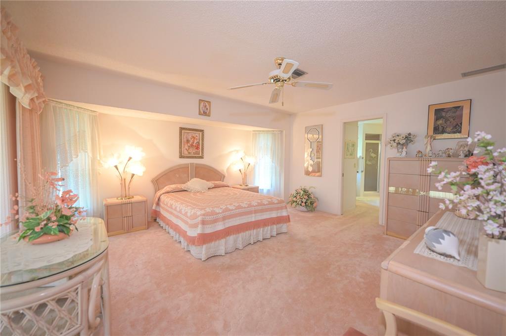 615 Toledo Road North Port, FL 34287 - Photo 8 of 16 a spacious bedroom with a bed and ceiling fan