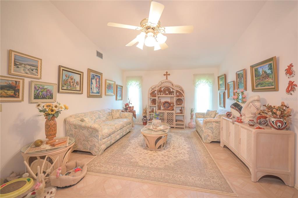 615 Toledo Road North Port, FL 34287 - Photo 10 of 16 a living room with furniture and chandelier