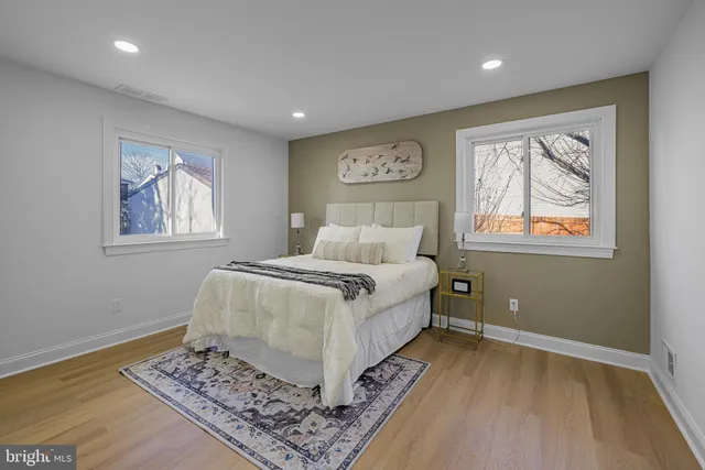 a bedroom with a large bed and a window