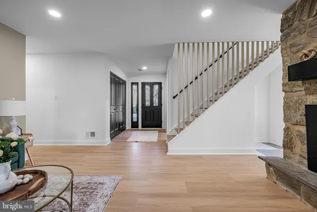 a view of entryway and hall with wooden floor
