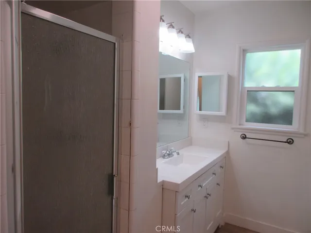 a bathroom with a sink vanity and mirror