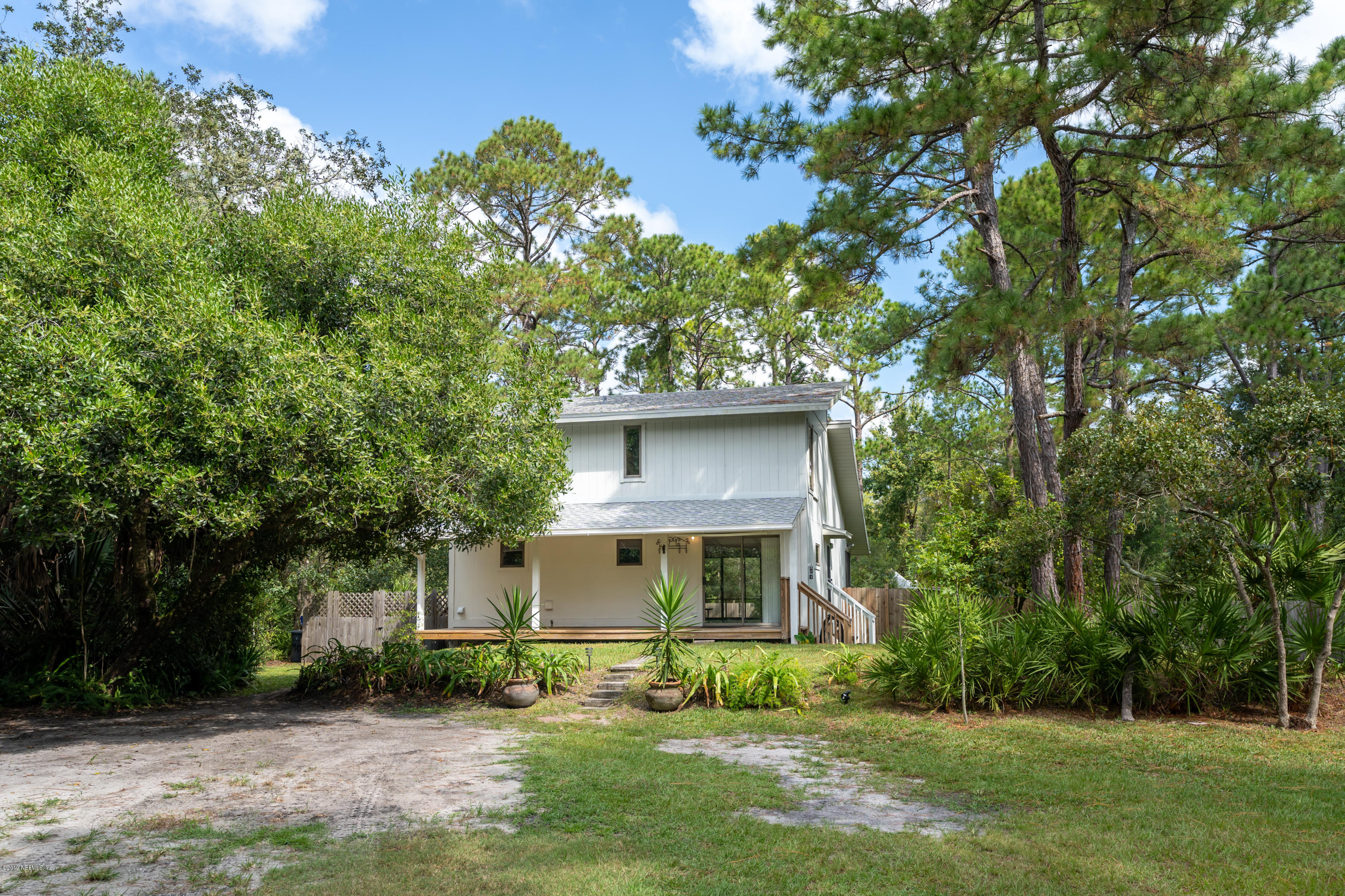 1090 Cherry Tree Road St. Augustine, FL 32086 - Photo 4 of 33 a front view of a house with a yard and a porch