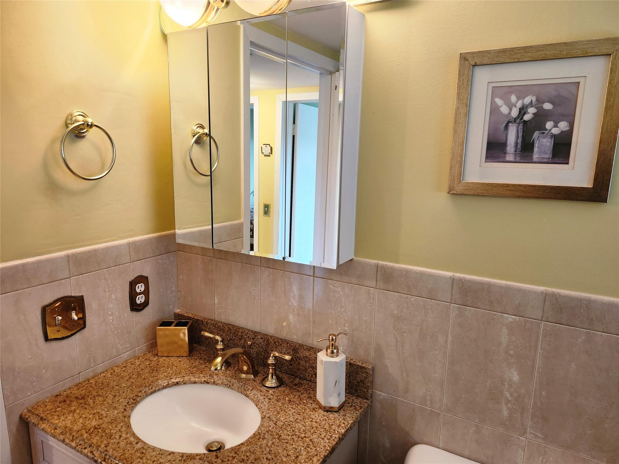 74 Preston Way Boca Raton, FL 33434 - Photo 16 of 28 a bathroom with a granite countertop sink and a mirror