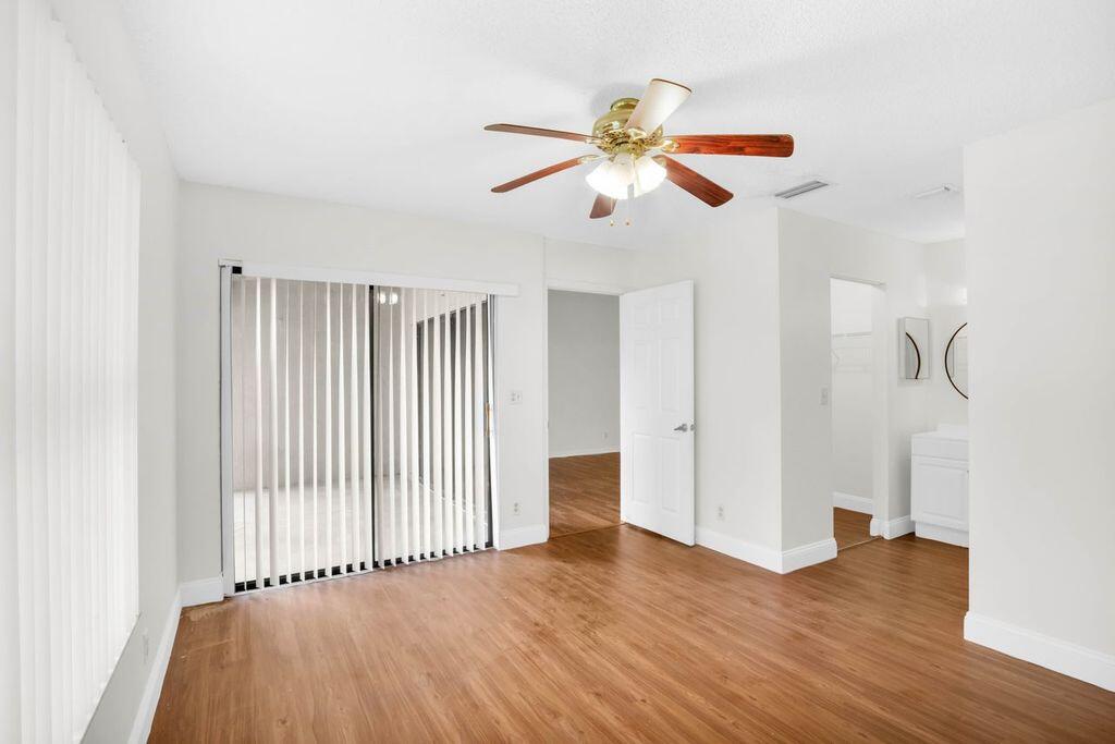 3300 Jaywood Terrace, Unit 2160 Boca Raton, FL 33431 - Photo 12 of 28 a view of an empty room with wooden floor and a window