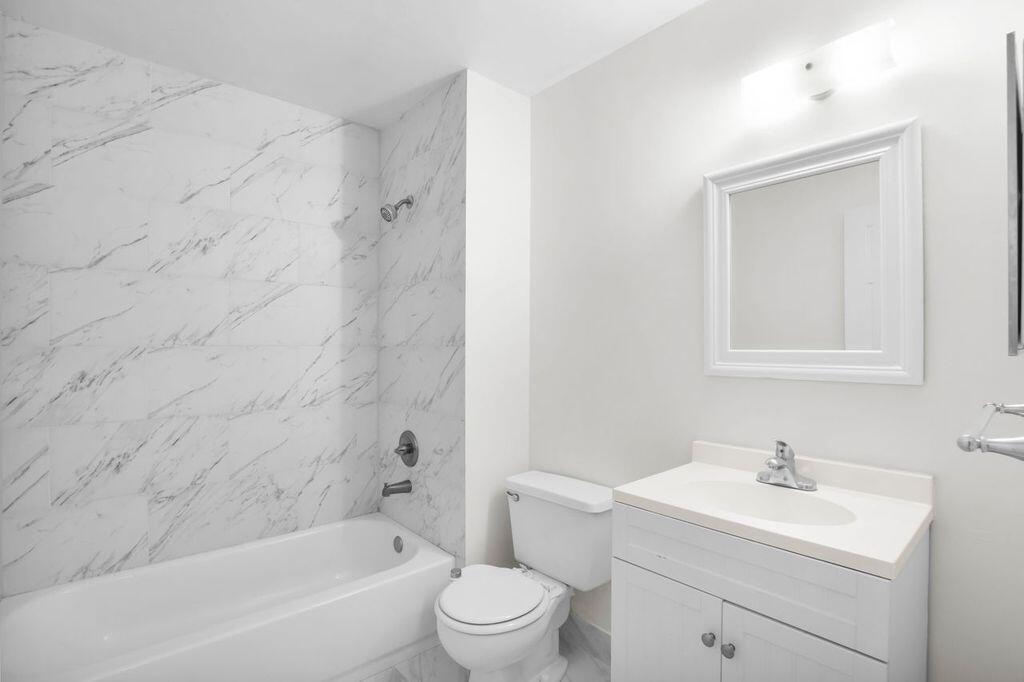 3300 Jaywood Terrace, Unit 2160 Boca Raton, FL 33431 - Photo 18 of 28 a bathroom with a toilet a sink a mirror and bathtub