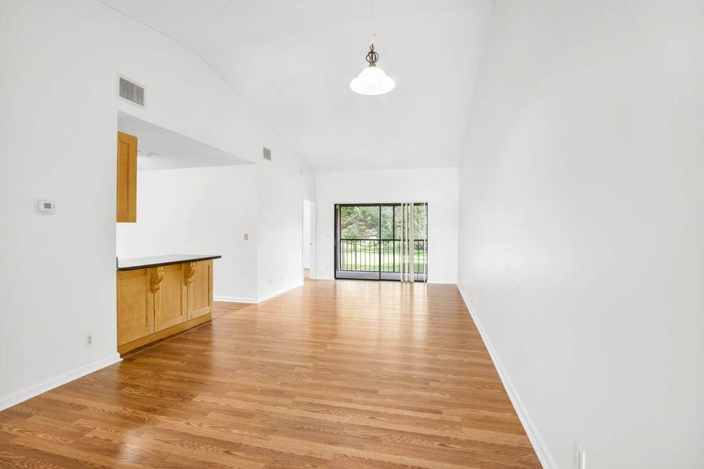3300 Jaywood Terrace, Unit 2160 Boca Raton, FL 33431 - Photo 3 of 28 a view of an empty room with wooden floor and a window