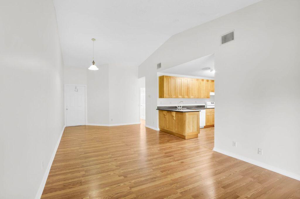 3300 Jaywood Terrace, Unit 2160 Boca Raton, FL 33431 - Photo 4 of 28 a view of an empty room with a window and wooden floor