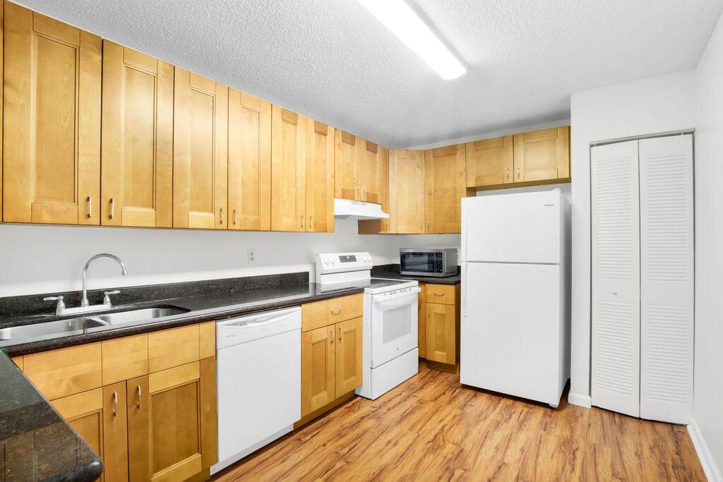 3300 Jaywood Terrace, Unit 2160 Boca Raton, FL 33431 - Photo 6 of 28 a kitchen with a refrigerator sink stove and cabinets