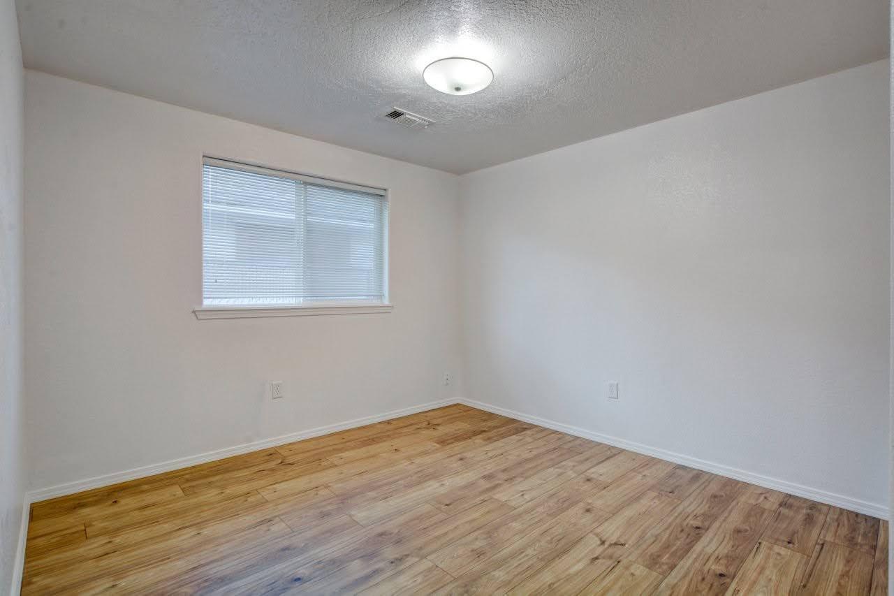 417 Crystal Drive Eagle Point, OR 97524 - Photo 20 of 35 an empty room with wooden floor and windows