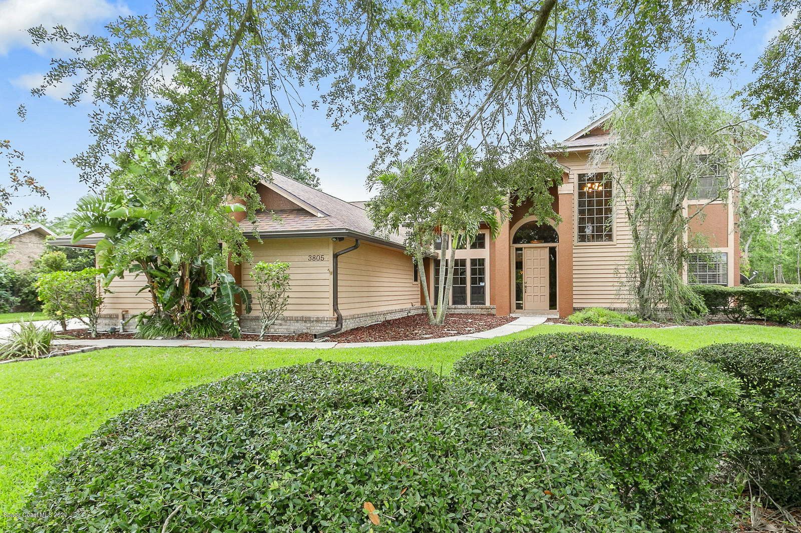3805 Shady Run Road Melbourne, FL 32934 - Photo 1 of 42 a front view of house with yard and green space