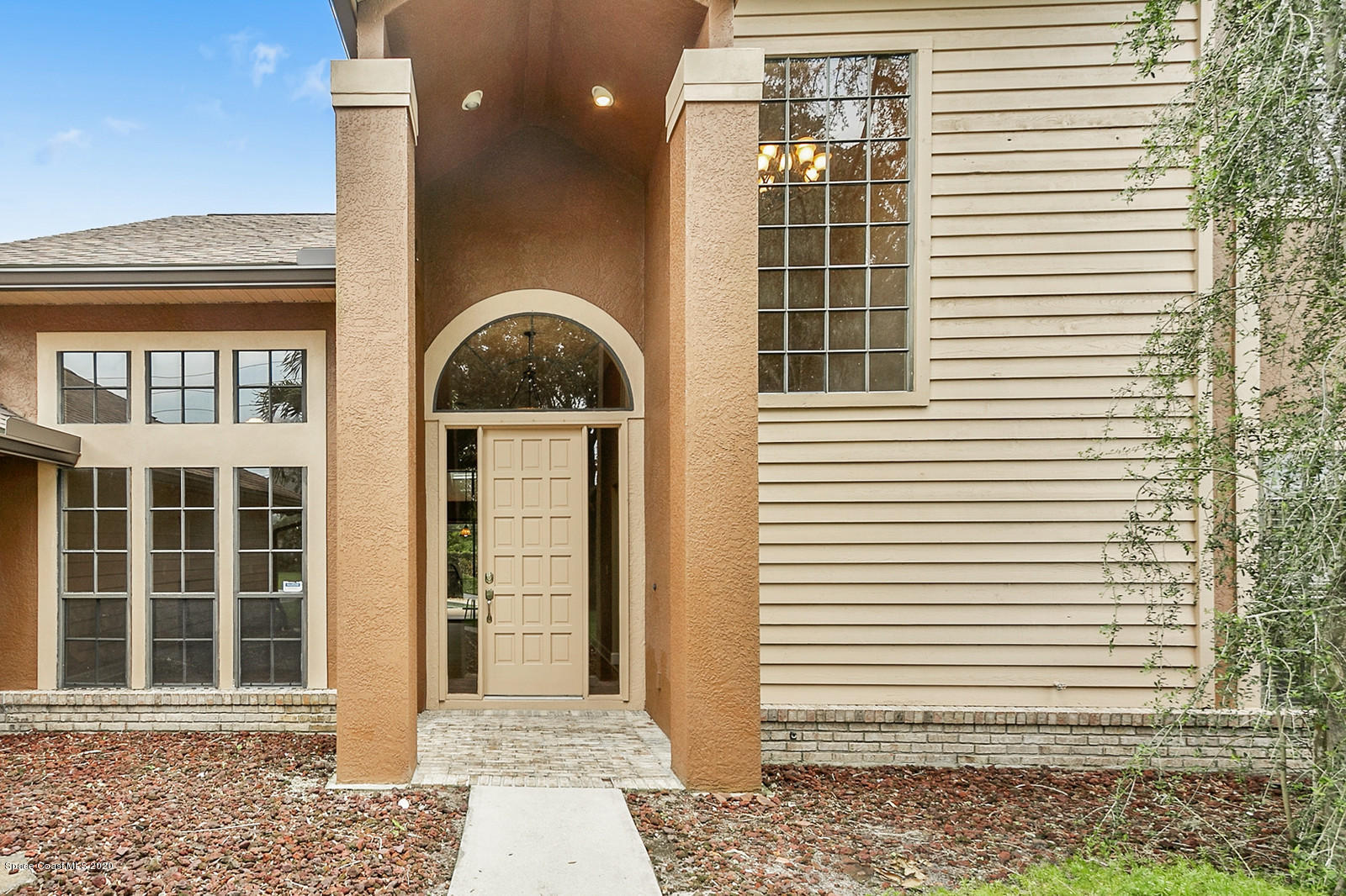 3805 Shady Run Road Melbourne, FL 32934 - Photo 11 of 42 a front view of a house with a yard