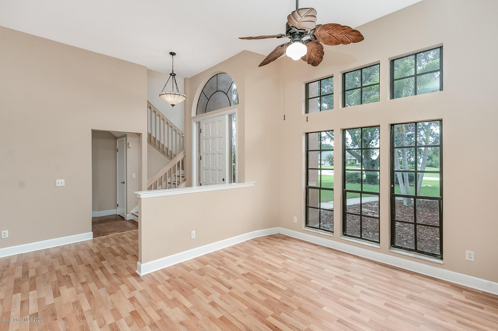 3805 Shady Run Road Melbourne, FL 32934 - Photo 14 of 42 a view of an empty room with wooden floor and a window