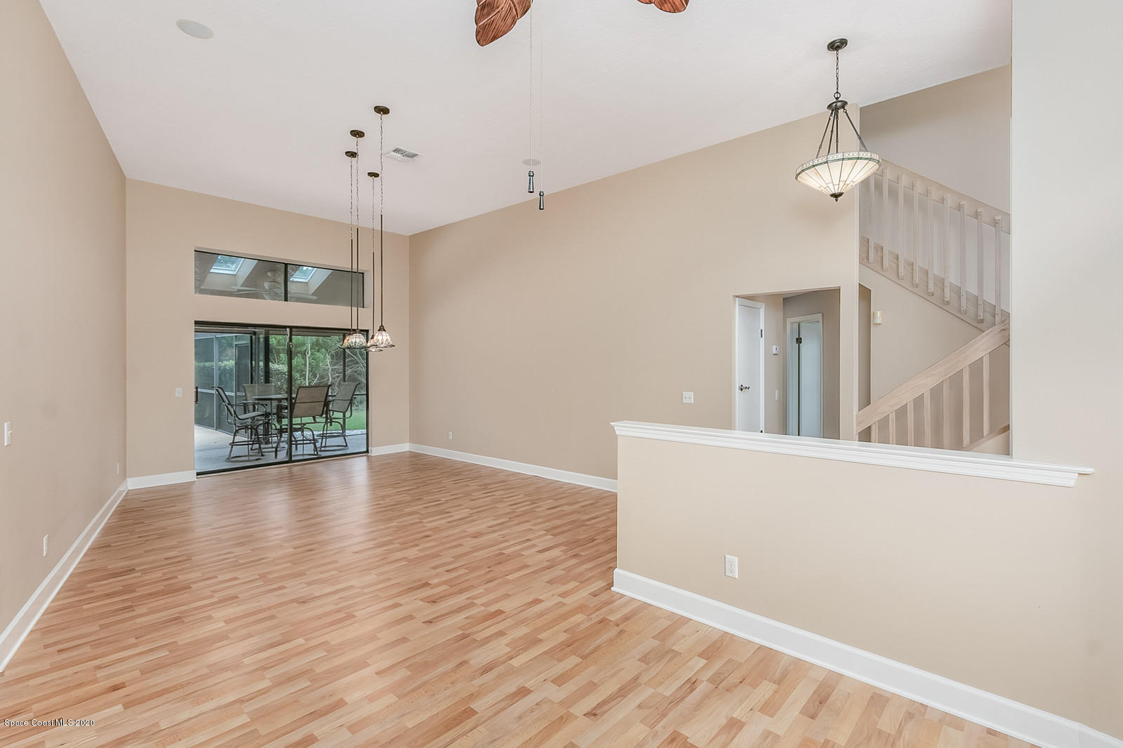 3805 Shady Run Road Melbourne, FL 32934 - Photo 15 of 42 a view of an empty room with wooden floor and a window