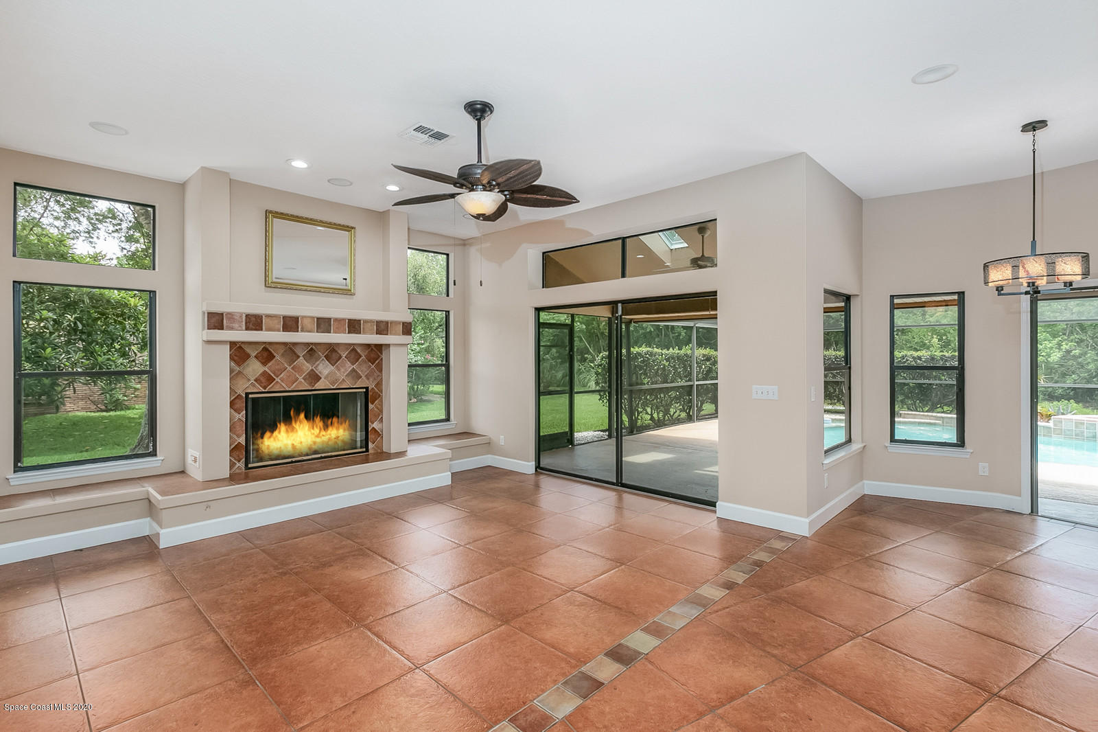 3805 Shady Run Road Melbourne, FL 32934 - Photo 16 of 42 a view of an empty room with a fireplace and a window