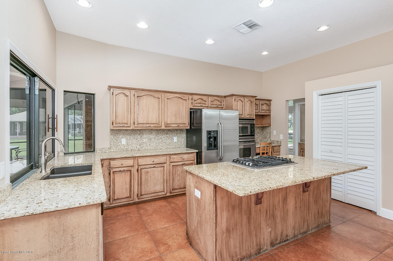 3805 Shady Run Road Melbourne, FL 32934 - Photo 19 of 42 a kitchen with stainless steel appliances granite countertop a stove a sink and a refrigerator