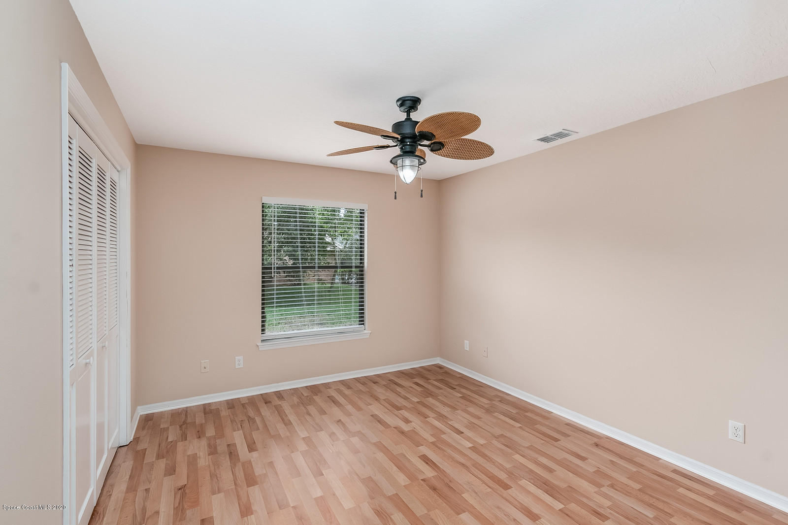 3805 Shady Run Road Melbourne, FL 32934 - Photo 20 of 42 wooden floor in an empty room with a window