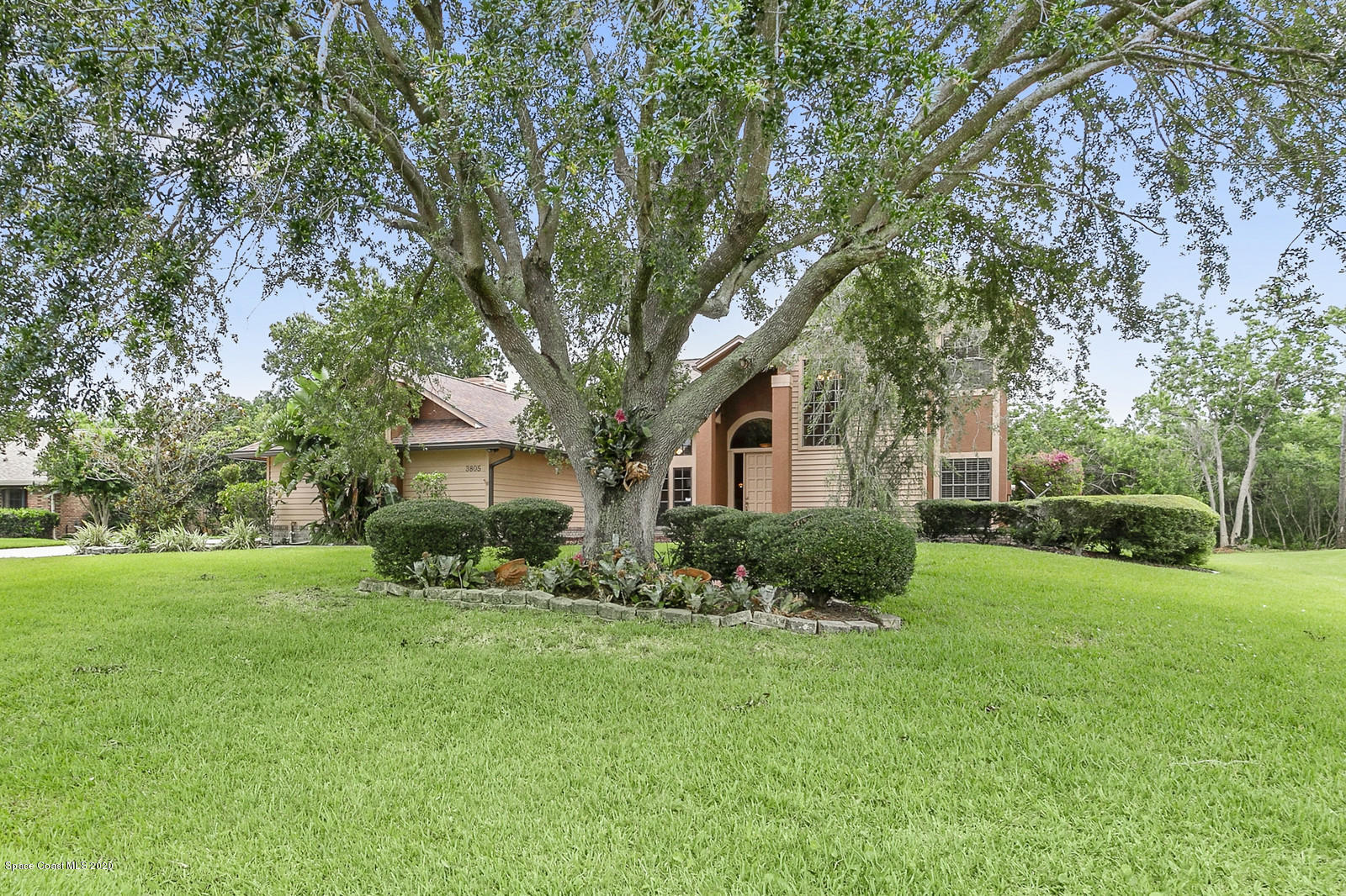 3805 Shady Run Road Melbourne, FL 32934 - Photo 3 of 42 a front view of a house with a yard and trees
