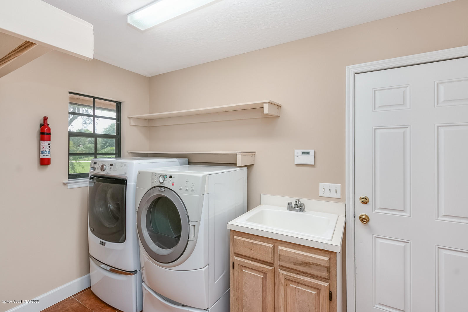 3805 Shady Run Road Melbourne, FL 32934 - Photo 22 of 42 a utility room with dryer and washer