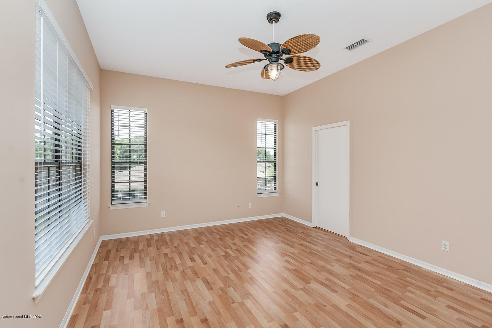 3805 Shady Run Road Melbourne, FL 32934 - Photo 27 of 42 a view of empty room with wooden floor and fan