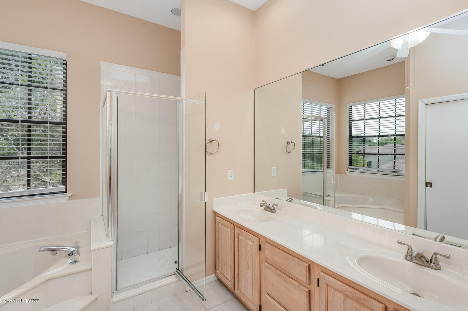 3805 Shady Run Road Melbourne, FL 32934 - Photo 28 of 42 a bathroom with a double vanity sink mirror double and bathtub