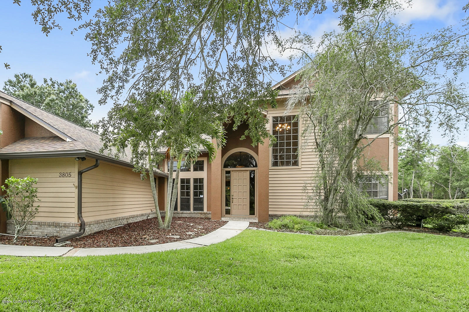 3805 Shady Run Road Melbourne, FL 32934 - Photo 4 of 42 a front view of a house with a garden and yard
