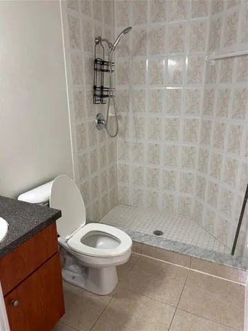 a white toilet next to a bathroom sink
