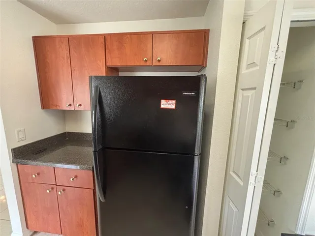 a close view of a refrigerator a sink and dishwasher