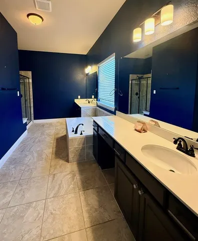 a bedroom with a bed and a flat tv screen