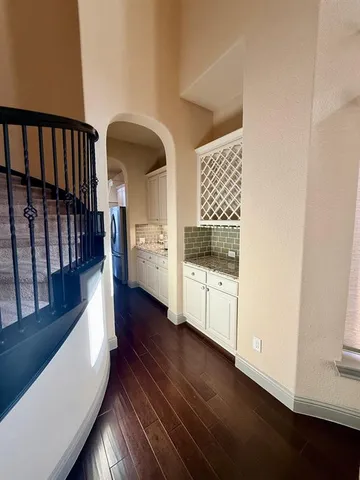 an entryway with wooden floor and windows