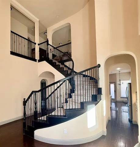 a living room with furniture and a hard wood floor