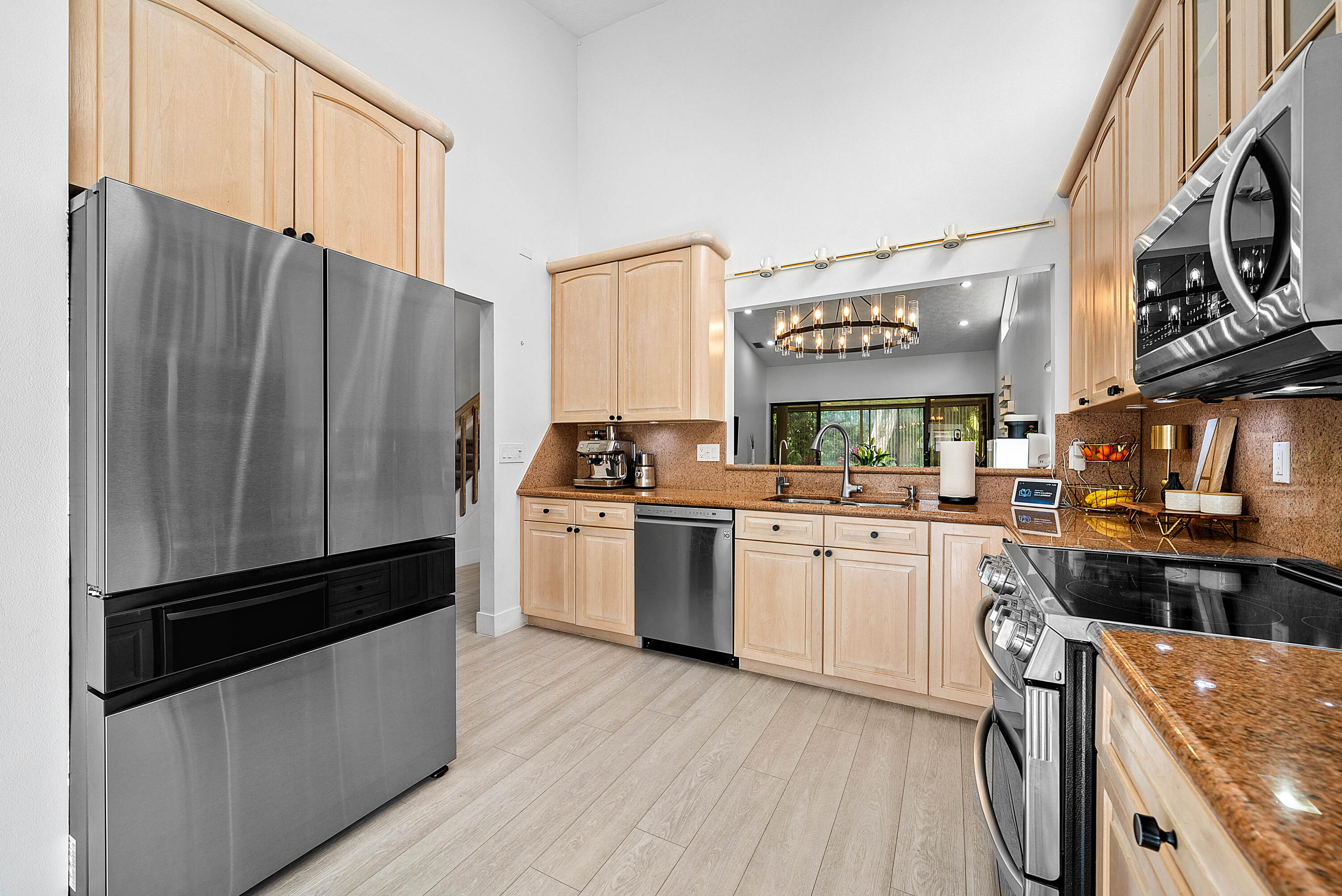 22627 Meridiana Drive Boca Raton, FL 33433 - Photo 12 of 58 a kitchen with stainless steel appliances a stove a sink and a refrigerator