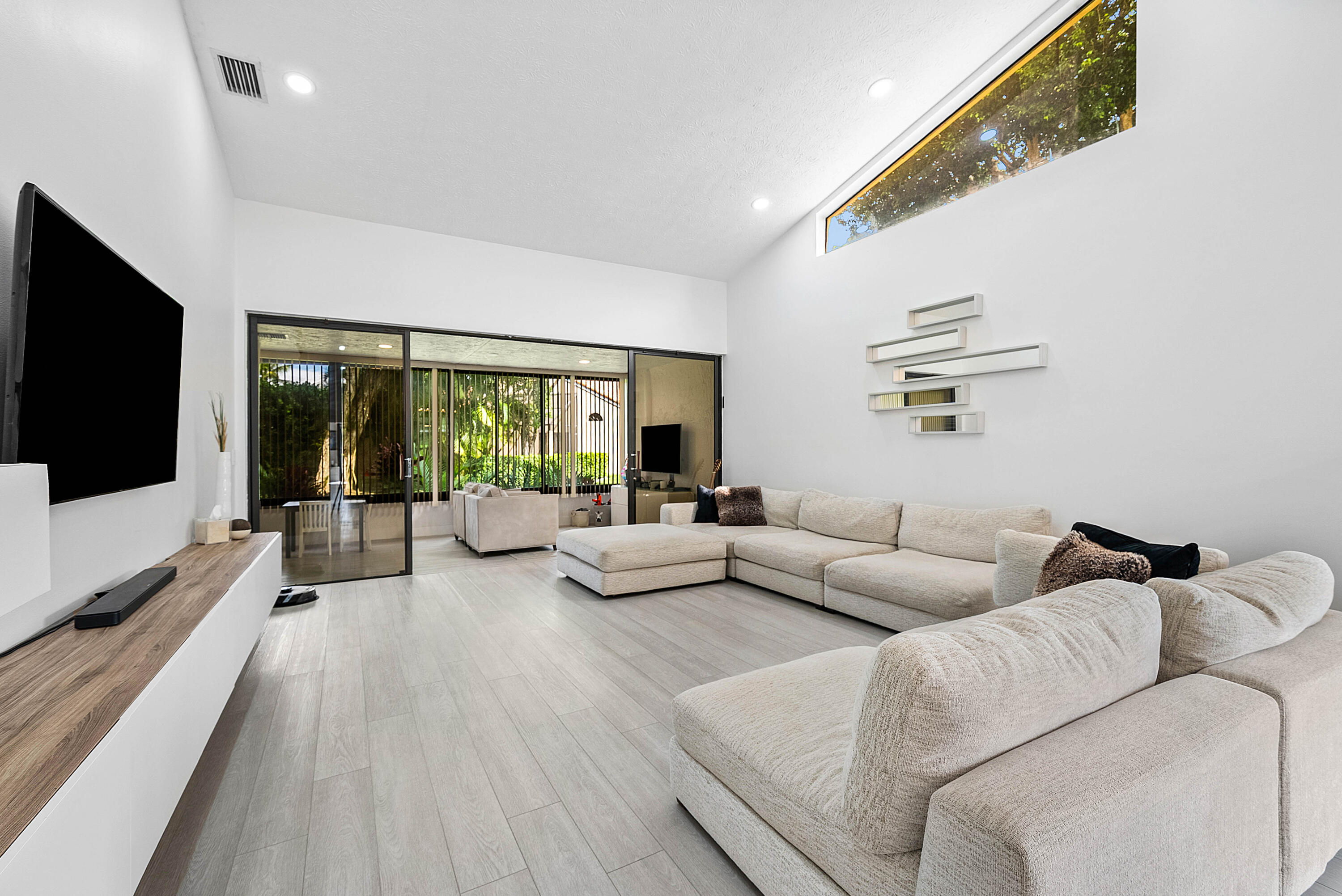 22627 Meridiana Drive Boca Raton, FL 33433 - Photo 19 of 58 a living room with furniture and a flat screen tv