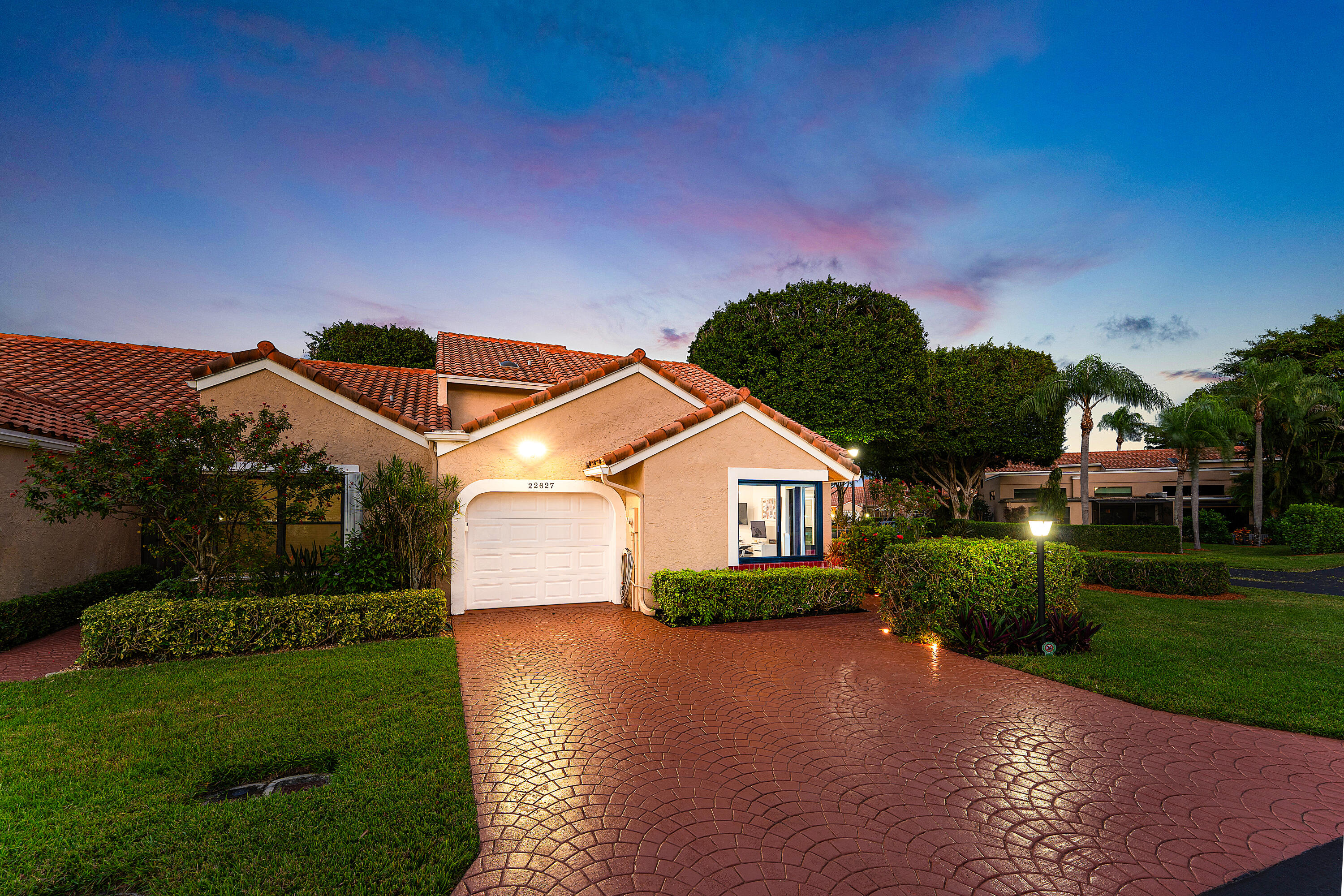 22627 Meridiana Drive Boca Raton, FL 33433 - Photo 37 of 58 a front view of a house with a garden