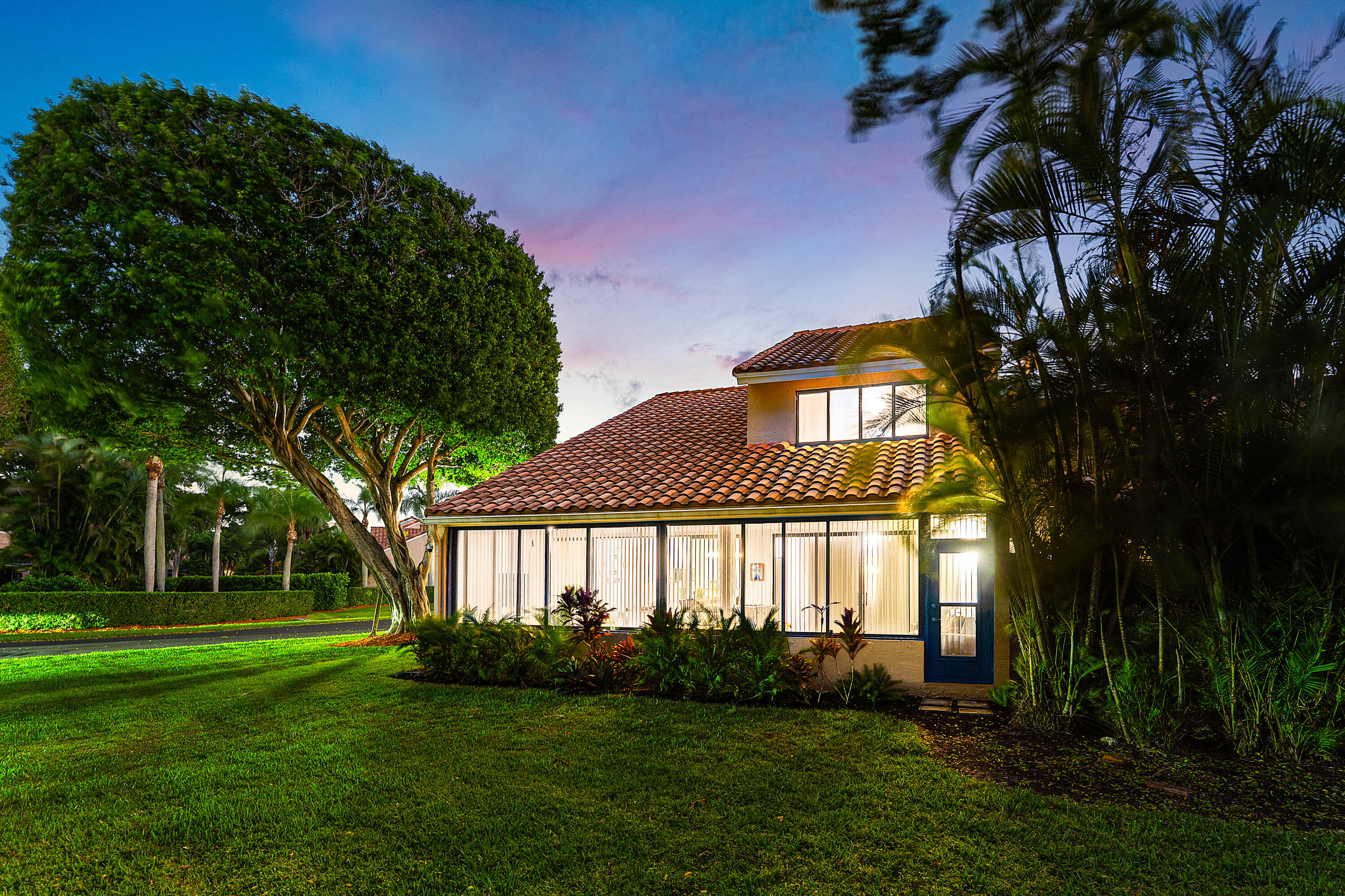 22627 Meridiana Drive Boca Raton, FL 33433 - Photo 42 of 58 a front view of a house with garden
