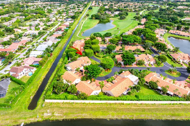 an aerial view of a house with a yard and plants
