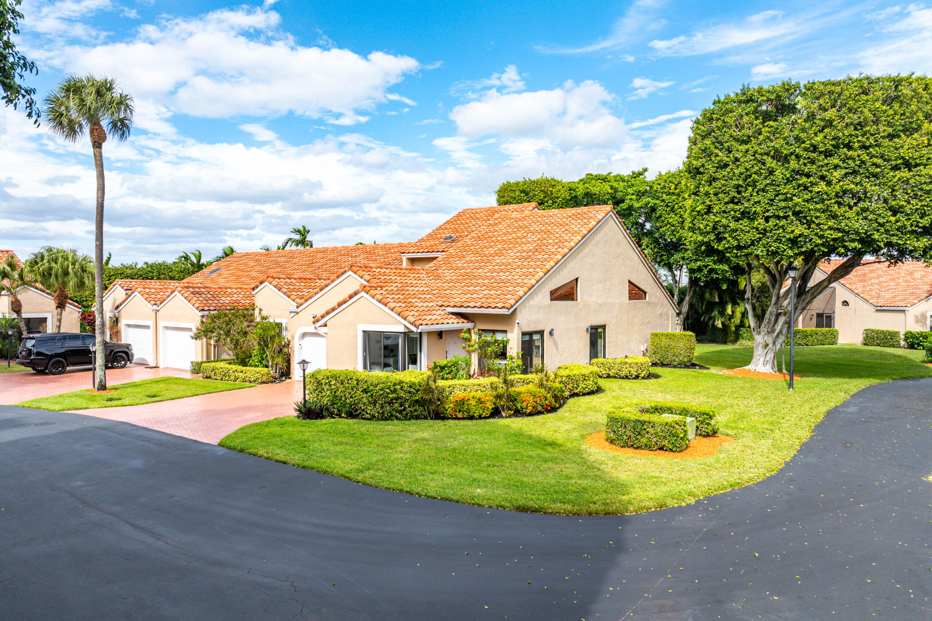 22627 Meridiana Drive Boca Raton, FL 33433 - Photo 47 of 58 a view of a house with a big yard and palm trees