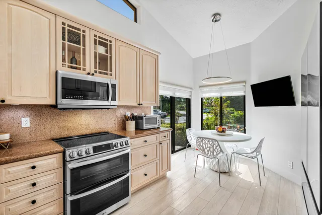 a dining room with furniture and a floor to ceiling window