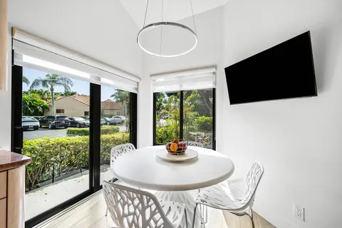a kitchen with stainless steel appliances granite countertop white cabinets a sink and dishwasher