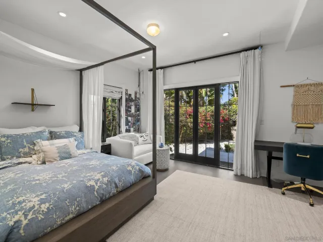 a bathroom with a tub a sink and a large window