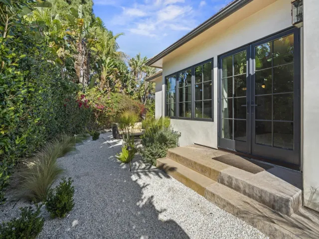a bedroom with a large bed and a desk