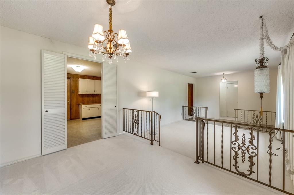 3511 Rio Grande Circle Dallas, TX 75233 - Photo 3 of 15 a view of a hallway with a chandelier