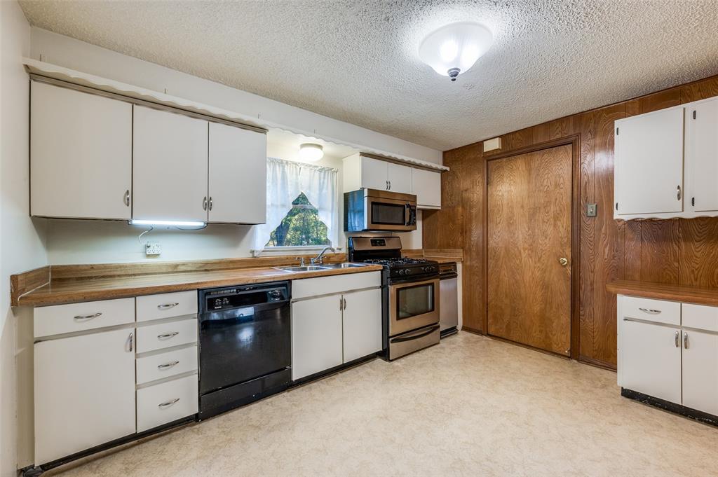 3511 Rio Grande Circle Dallas, TX 75233 - Photo 5 of 15 a kitchen with stainless steel appliances granite countertop a stove a sink and a refrigerator