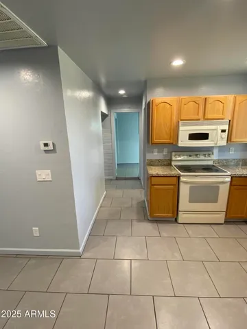 a kitchen with a sink a stove top oven and cabinets