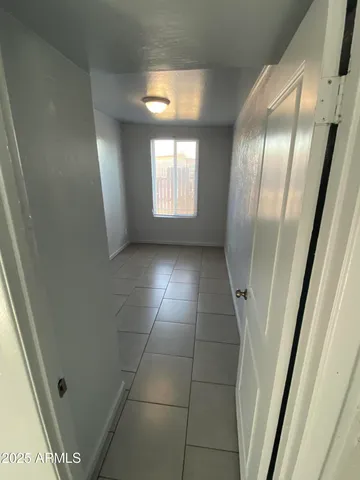 a view of an empty room and a window