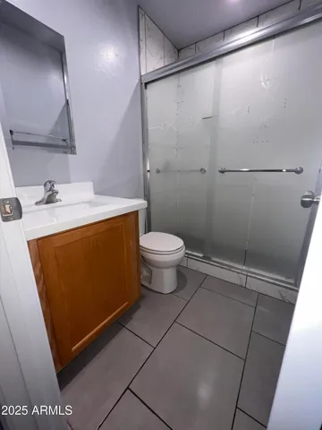 an empty room with white walls and tiles