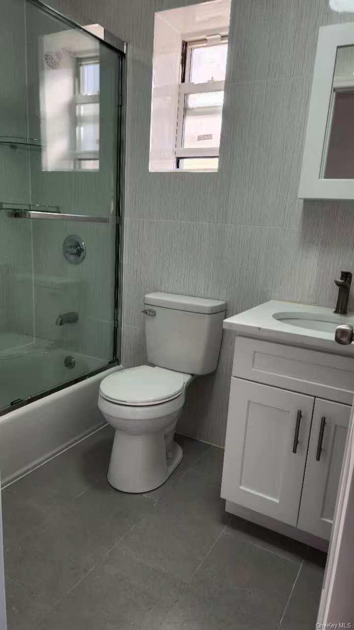 12-39 116th Street, Unit 2 Queens, NY 11356 - Photo 1 of 1 a white toilet sitting next to a bathroom sink