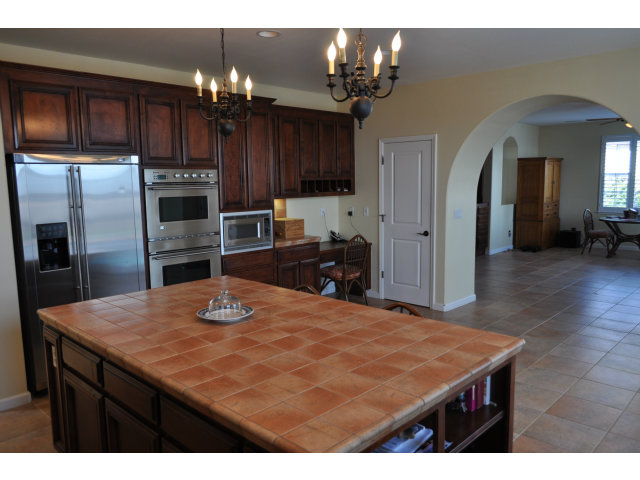 6560 Eagle Ridge Court Gilroy, CA 95020 - Photo 8 of 18 a kitchen with kitchen island a sink refrigerator and cabinets