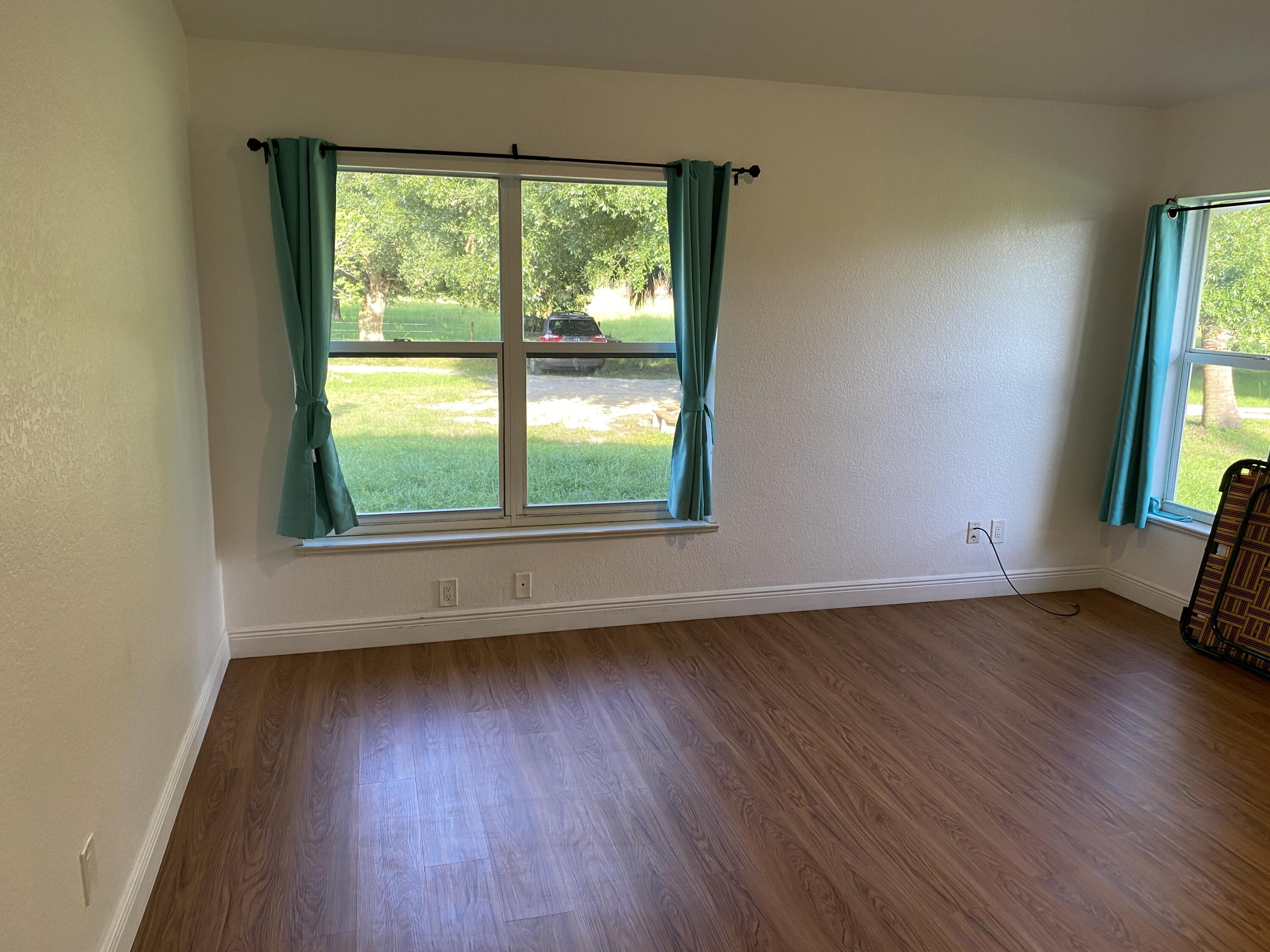 5425 Koblegard Road Fort Pierce, FL 34951 - Photo 12 of 33 an empty room with wooden floor and windows