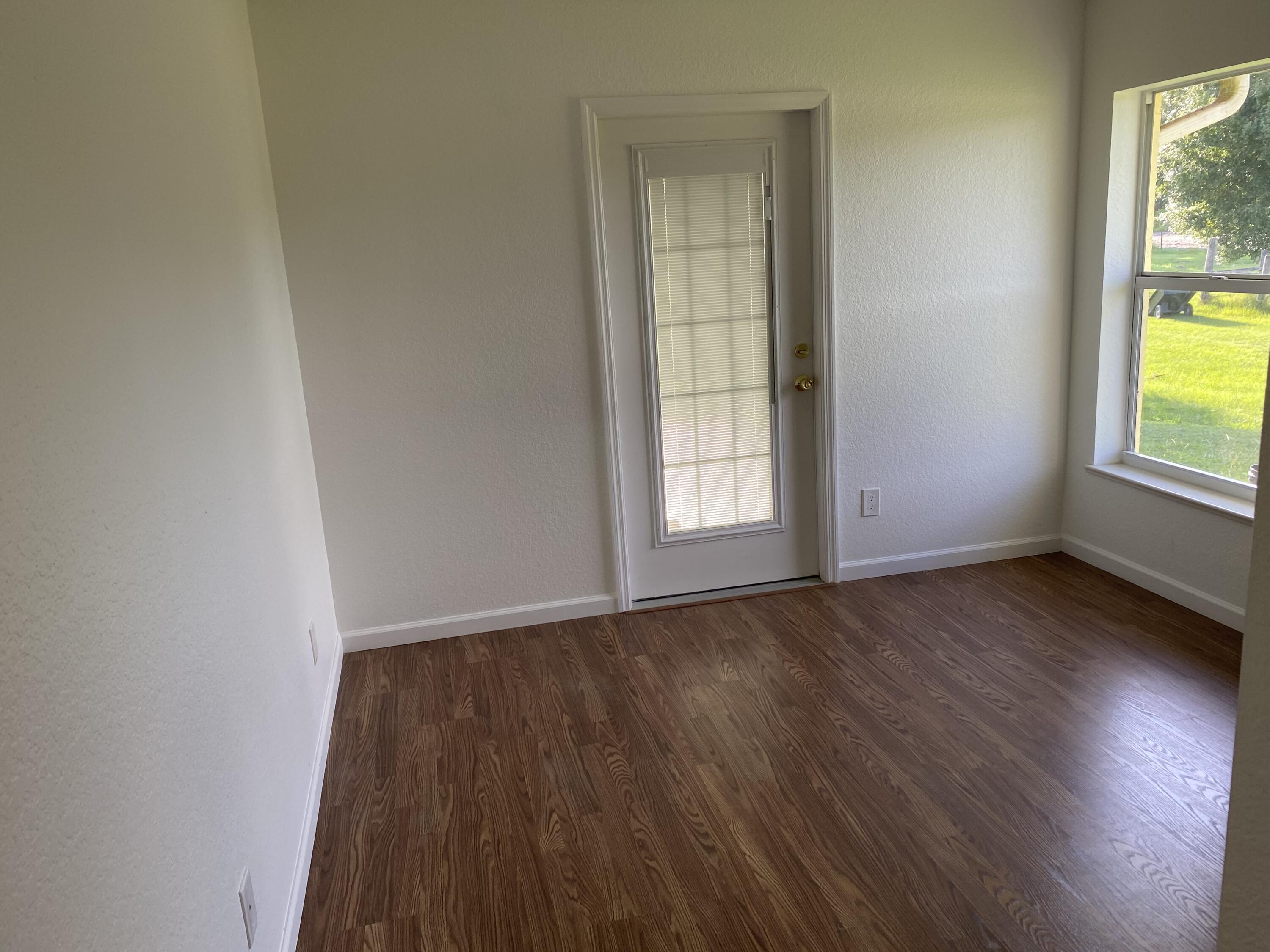 5425 Koblegard Road Fort Pierce, FL 34951 - Photo 19 of 33 an empty room with wooden floor and windows