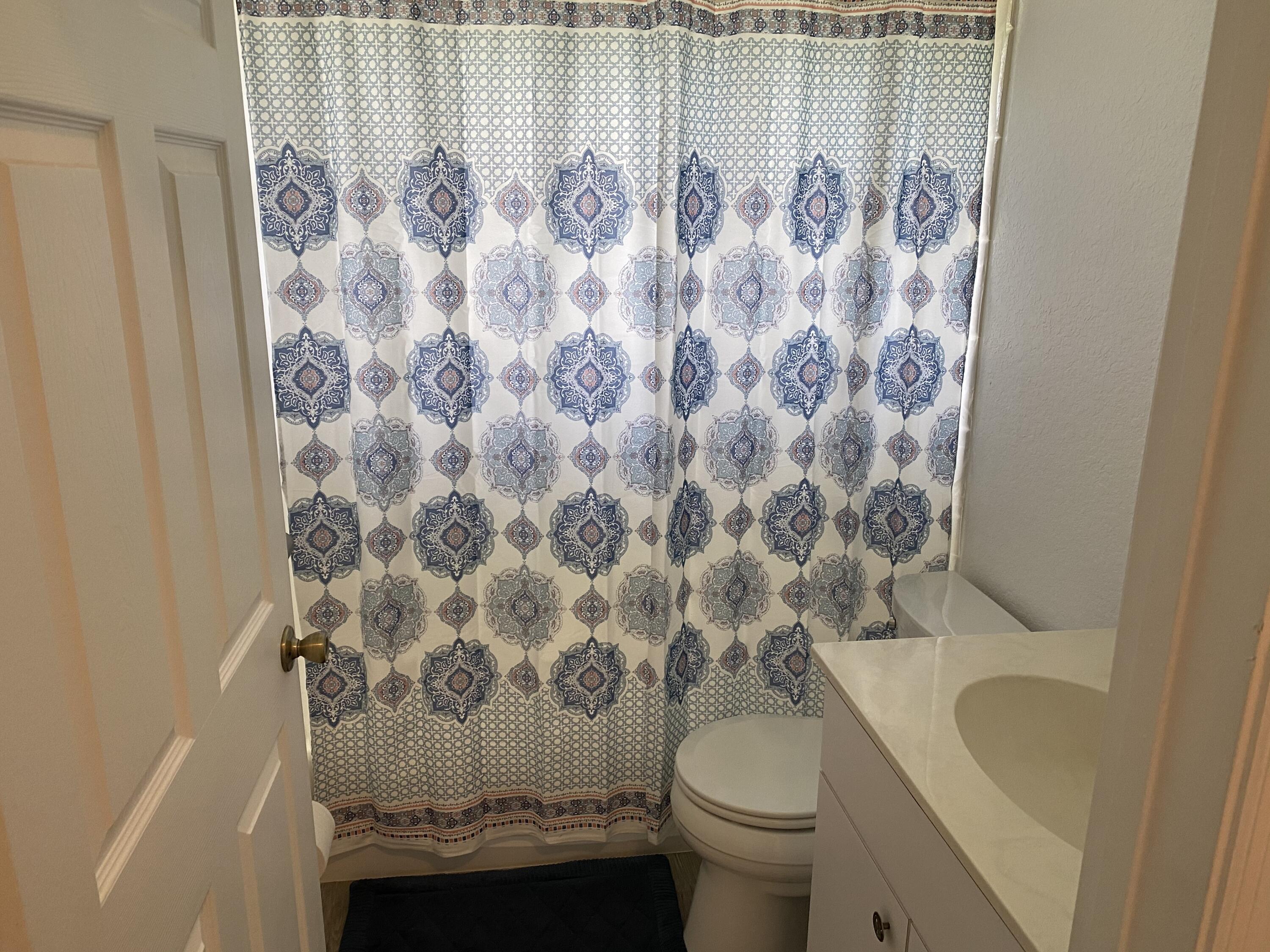 5425 Koblegard Road Fort Pierce, FL 34951 - Photo 20 of 33 a bathroom with a toilet and shower curtain